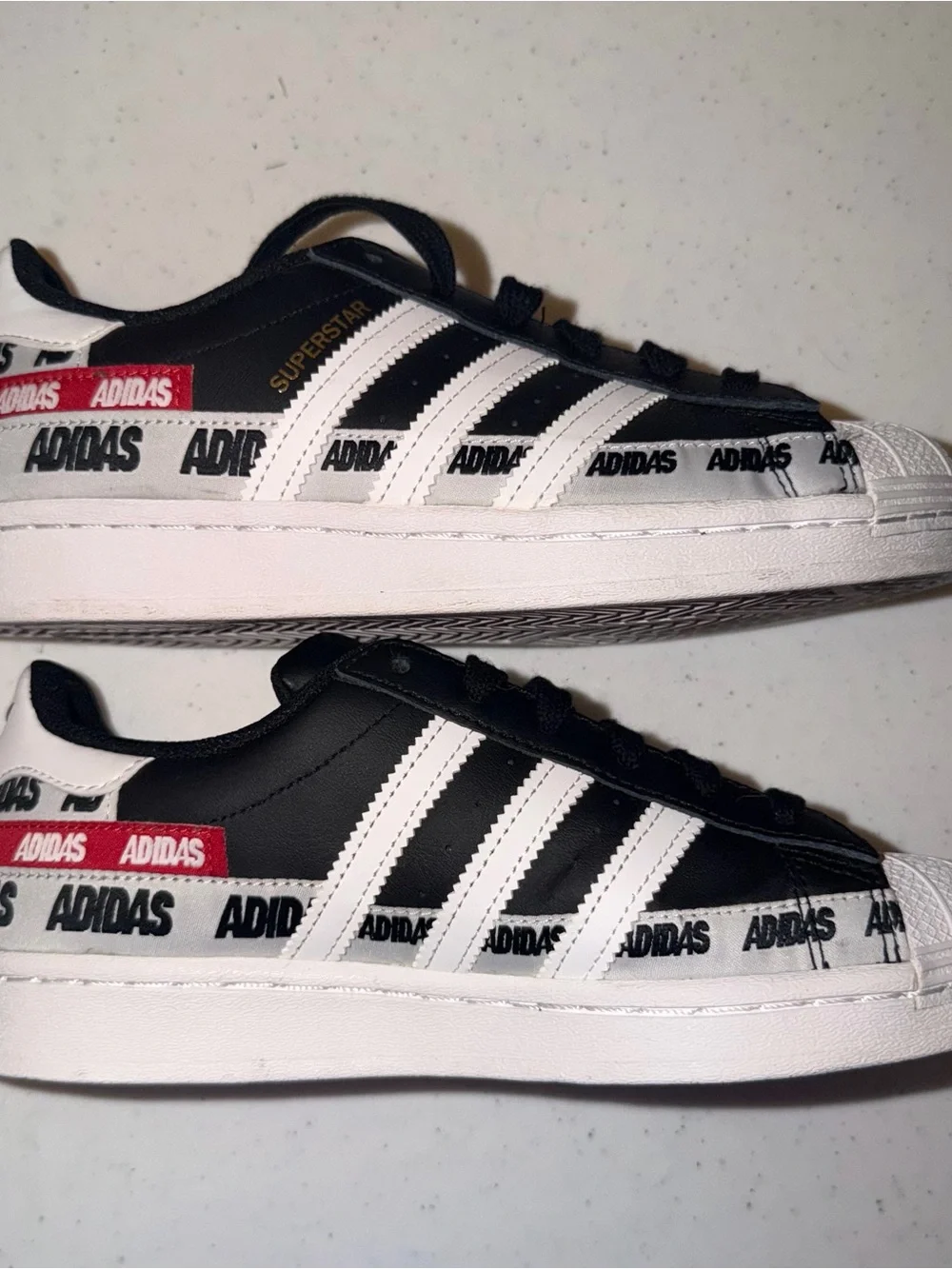 adidas Black & White Superstar Sneakers with Red Logo Tape